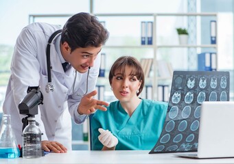 Two doctors discussing x-ray MRI image in hospital