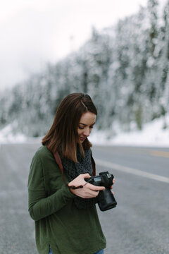 Beautiful Woman Looking at back of Camera in Winter Mountain Scene