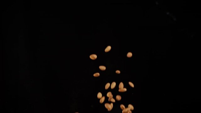 Slow motion explosion of almonds flying in flames