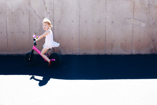 Cute Little Girl Riding a Pink Bike