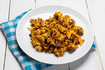 Scrambled eggs with chorizo for breakfast on white background. Mexican  food