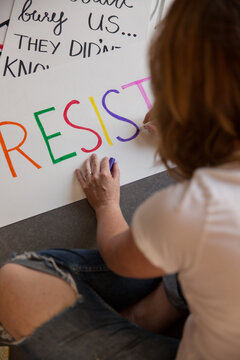 Woman making protest signs.