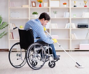 Disabled man on wheelchair cleaning home