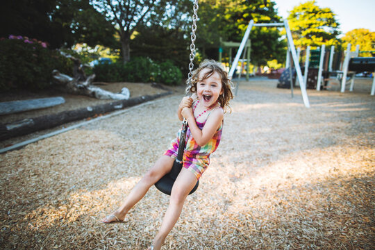 Young girl on zip-line swing in summer
