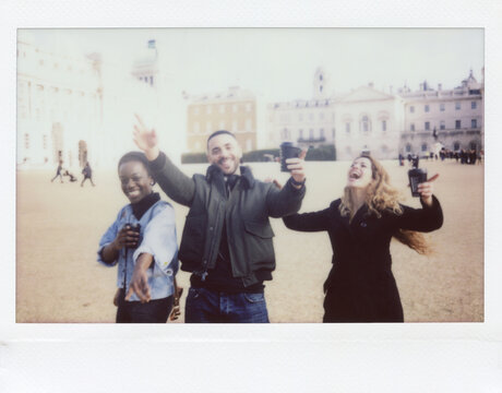 Happy friends with coffee to go on square.