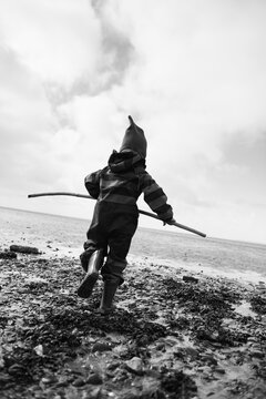 Boy explores mudflat at north sea