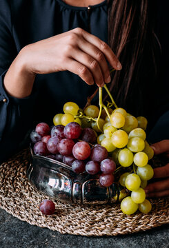 Woman holding fresh juicy grape