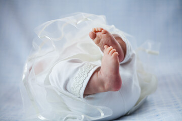 Newborn baby legs . Selective focus., Baby lying on the white carpet. Background. Copy space. similar images