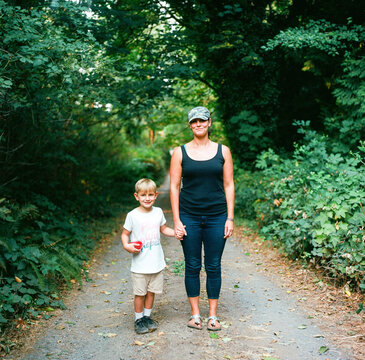 Mother and son stand in country lane