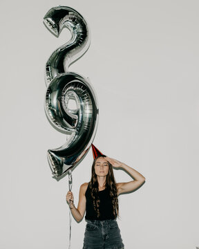 A Woman Holding 29 Number Birthday Balloons