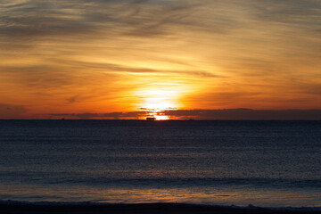 Spring Sunrise over the Pacific ocean in Chiba Japan. An amazing orange glow with wispy clouds makes this a beautiful background image.