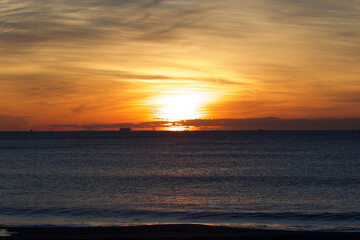 Spring Sunrise over the Pacific ocean in Chiba Japan. An amazing orange glow with wispy clouds makes this a beautiful background image.