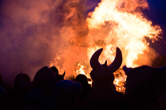 Vikings gathering around a large bonfire at night