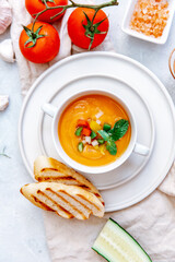 Soup tomato in white bowl with parsley and tomatoes