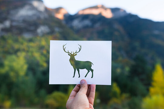 Deer silhouette on mountain background