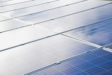 Closeup view of photovoltaic panels surface which installed on the building's roof after washing and cleaning by the company's staffs in the afternoon of the day.