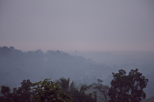 Sunrise in the indonesian jungle with a temple in the background