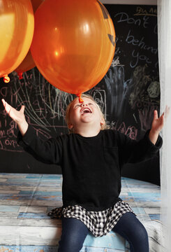 Child playing with balloons