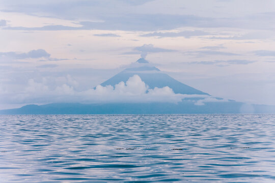 Volcano or mount Mayon blue silhouette and sea, Luzon, Philippines