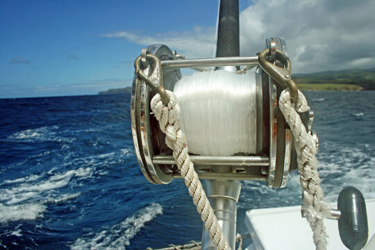 View of a large fishing reel on the end of a boat