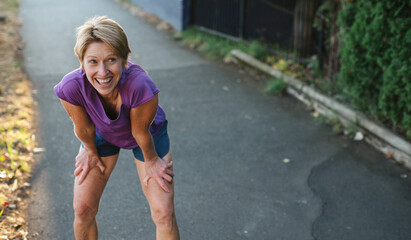 Healthy mature woman on urban morning run