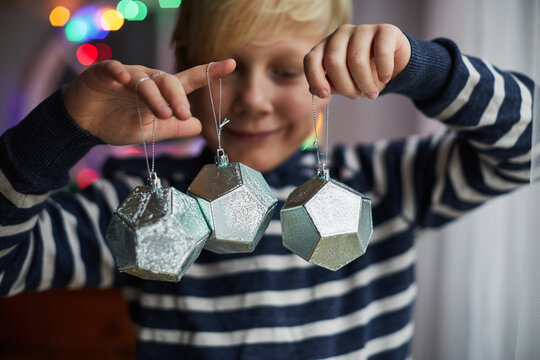 Child holding Christmas decorations