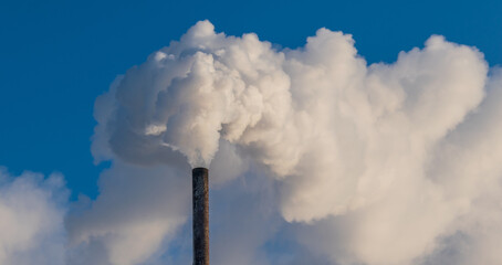 A large cloud of white smoke from the chimney.