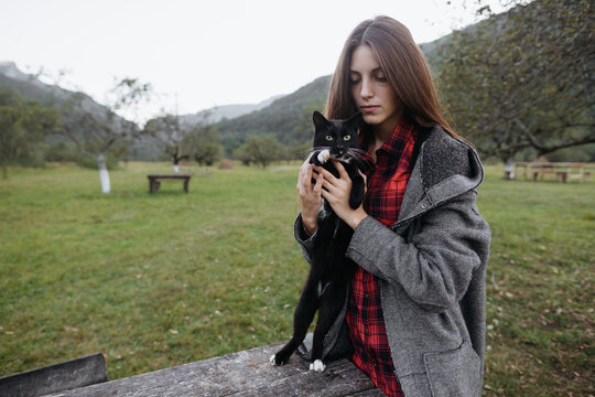 Young female and black cat