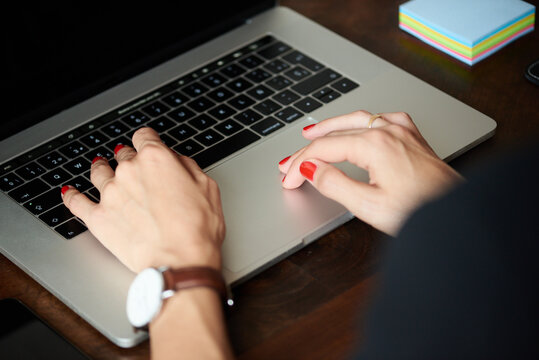 Hands of woman working at laptop