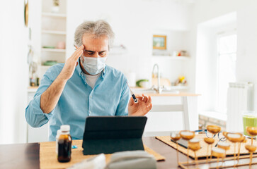 Senior man consulting with a doctor on his laptop