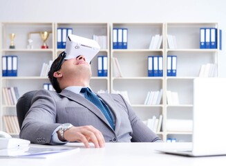 Businessman with virtual reality glasses in modern technology co