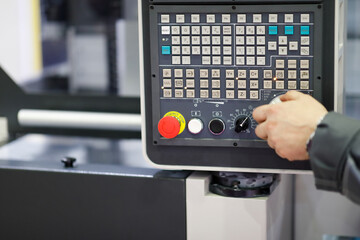 working with control panel of CNC machining center