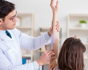 Doctor checking patients joint flexibility