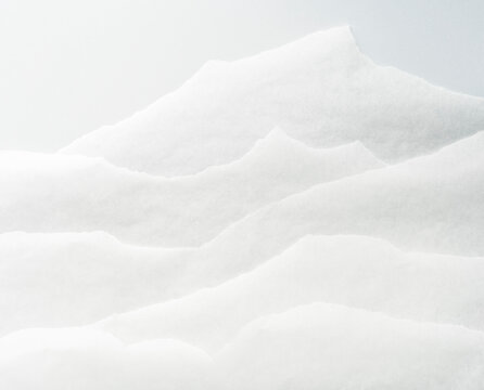 White torn papers representing mountains in the distance