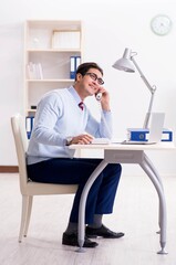 Businessman employee talking on the office phone