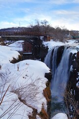 Winter view of the Great Falls of the Passaic River, part of the Paterson Great Falls National Historical Park in New Jersey, United States, after a snow storm.