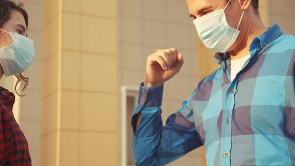 dad and daughter touch elbows social distance. bump avoid greeting. coronavirus pandemic concept. people meeting greet each other at distance observing covid 19 social distance. bump avoid greeting