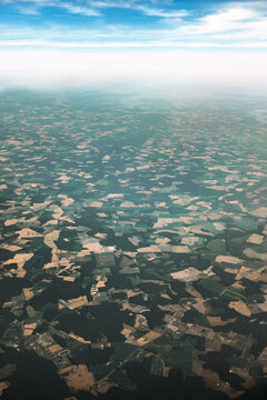 earth surface of patchwork farmland and fields shot from the sky