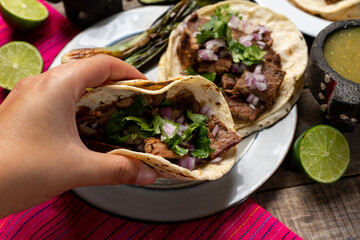 Grilled beef steak tacos on wooden background. Mexican food