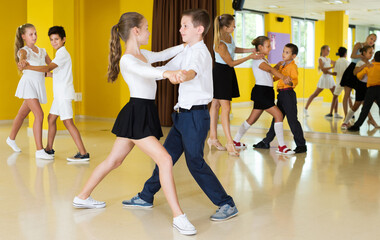 Young children enjoying of partner dance in class