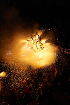 Group of people under a circle of spinning fire