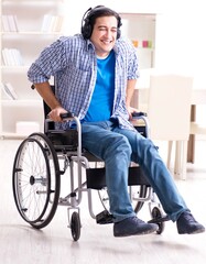 Obraz na płótnie Canvas Disabled man listening to music in wheelchair