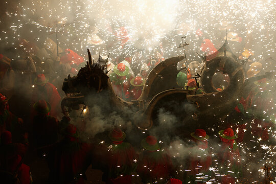 Cultural dragon surrounded by sparks and people
