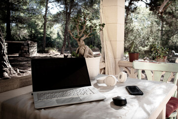 Laptop and headphones on the terrace table
