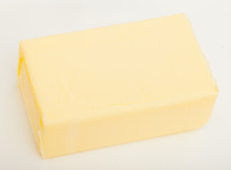 Piece of tasty fresh butter on white background..