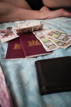 Passports and money laid out on bed