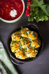 Garlic bread, buns. Bread rolls with garlic and parsley and soup borscht. overhead, vertical