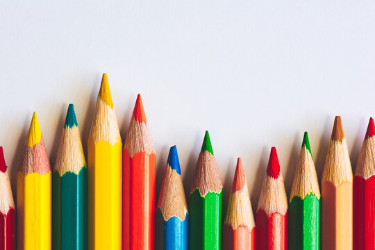 Colorful pencils on white sheet of paper