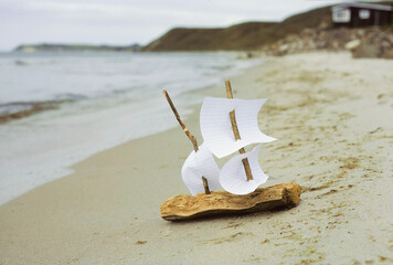 Miniature bark boat on beach