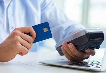 Man processing credit card transaction with POS terminal